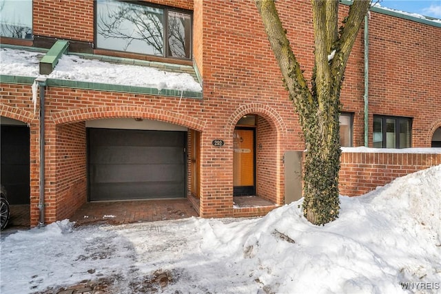 view of front of house featuring a garage and brick siding