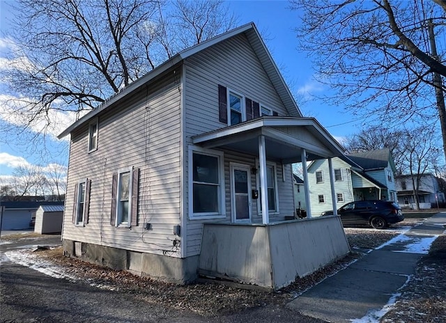 view of side of property featuring a porch