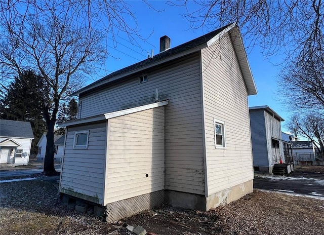 view of side of home with a chimney