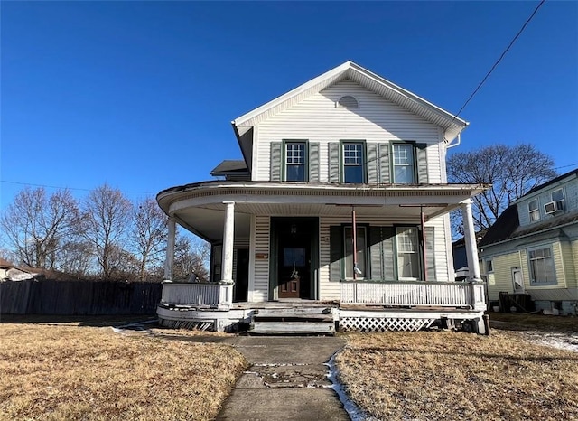 view of front of house featuring a porch and fence