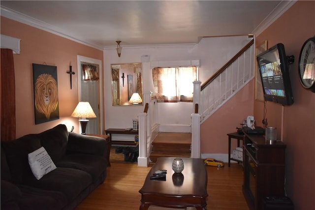 living area featuring crown molding, stairway, and wood finished floors