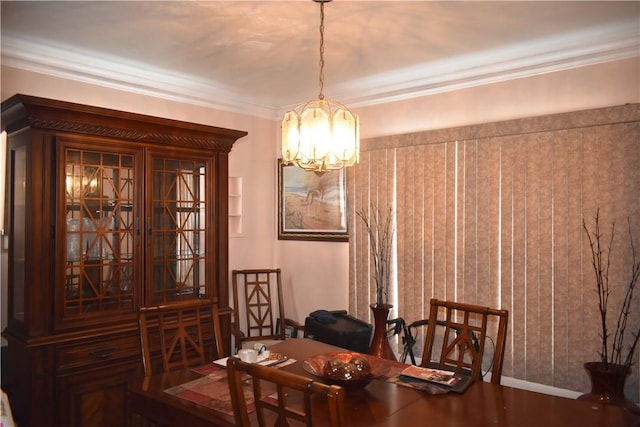 dining area with baseboards, a chandelier, and crown molding