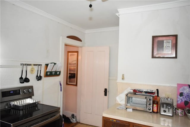 kitchen featuring ornamental molding, light countertops, decorative backsplash, and stainless steel electric stove