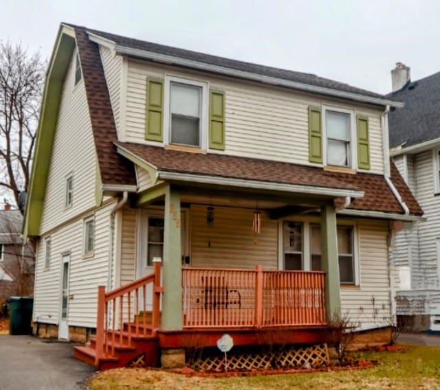 view of front of house featuring a porch and a shingled roof