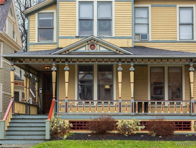 exterior space featuring a shingled roof and a porch