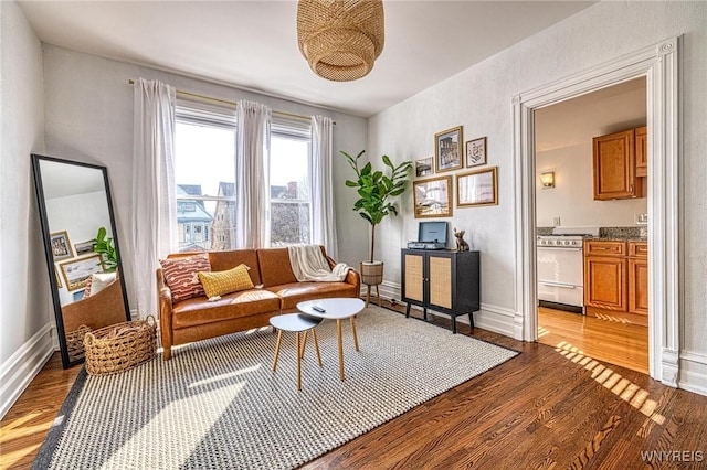 living room with baseboards and light wood-style floors