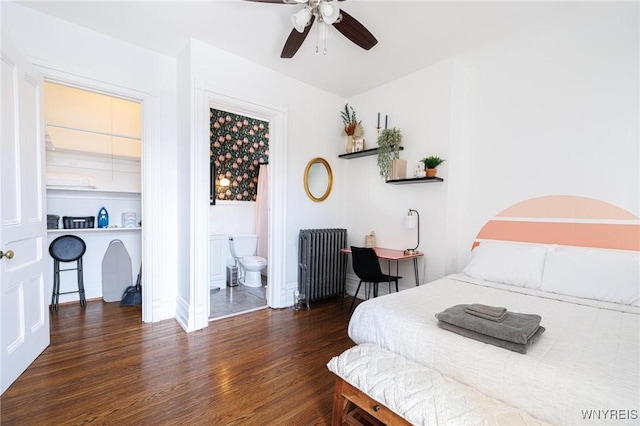 bedroom featuring dark wood-style flooring, baseboards, ensuite bath, and radiator heating unit