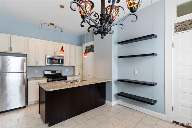 kitchen with appliances with stainless steel finishes, white cabinets, a sink, light stone countertops, and a chandelier