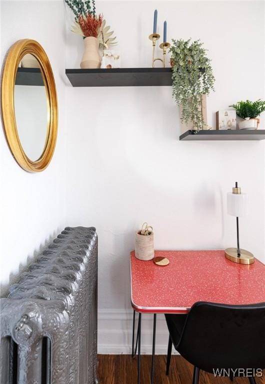 dining room with dark wood-style flooring and baseboards