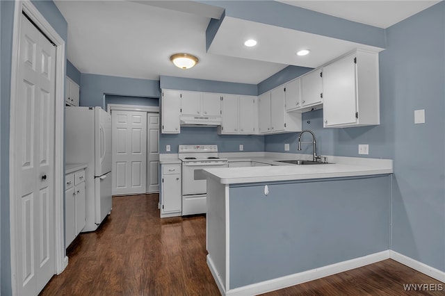 kitchen with a peninsula, white appliances, a sink, white cabinets, and light countertops