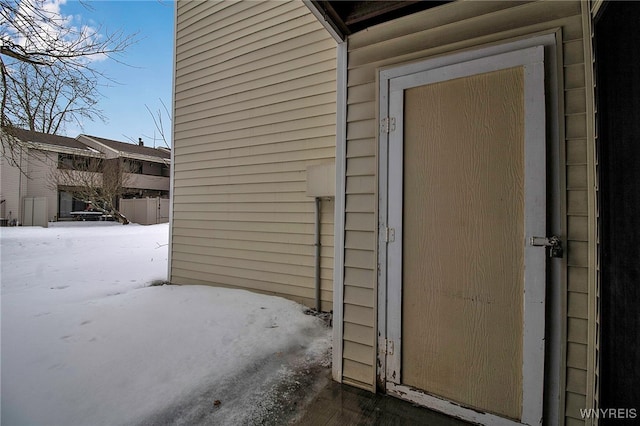 view of snow covered property entrance