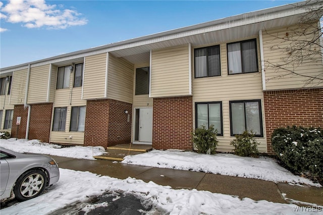 townhome / multi-family property featuring brick siding