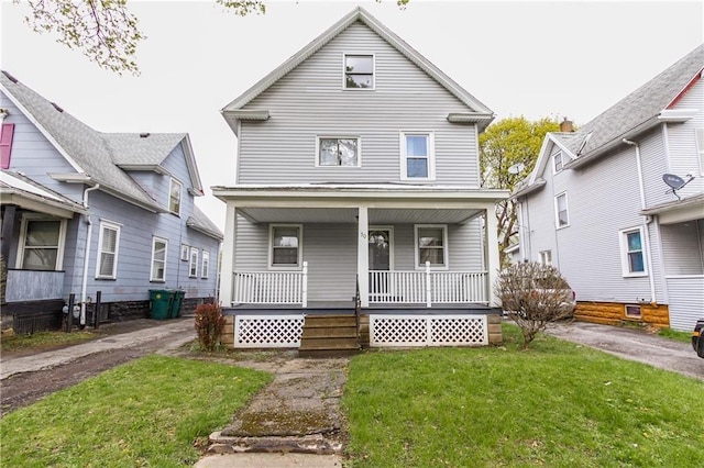 traditional style home featuring a porch and a front yard