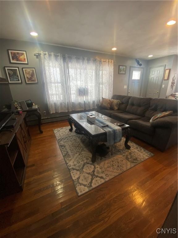 living room with dark wood-style flooring and recessed lighting