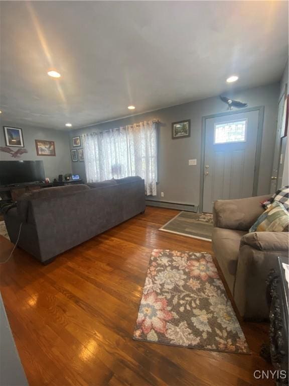 living room with dark wood-style floors, a baseboard heating unit, and recessed lighting