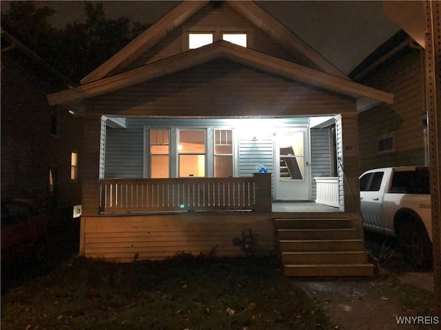 back of property with covered porch