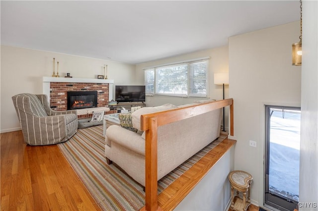 living area featuring light wood-style floors and a fireplace