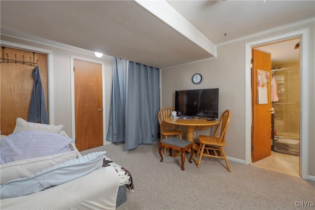 bedroom featuring ornamental molding and light colored carpet