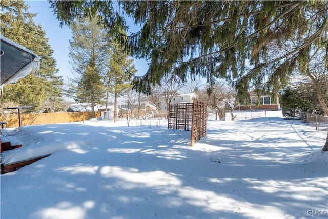 yard layered in snow with fence