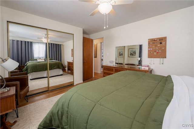 bedroom with a closet, ceiling fan, and wood finished floors