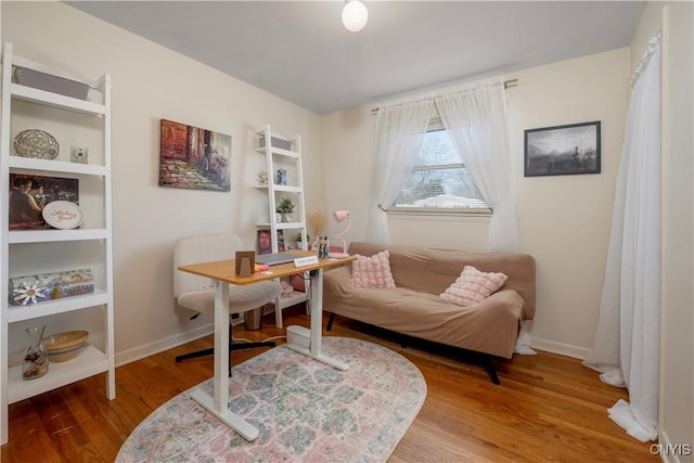 office area with baseboards and wood finished floors