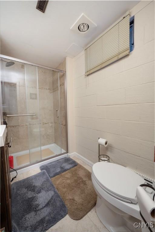 full bathroom with visible vents, a shower stall, toilet, and vanity