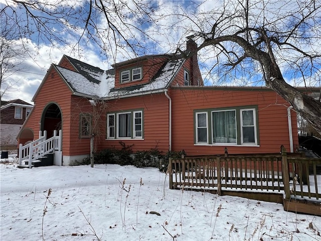 view of snow covered exterior featuring a chimney