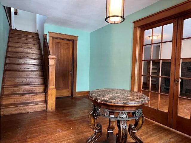 dining area with french doors, stairway, dark wood finished floors, and baseboards