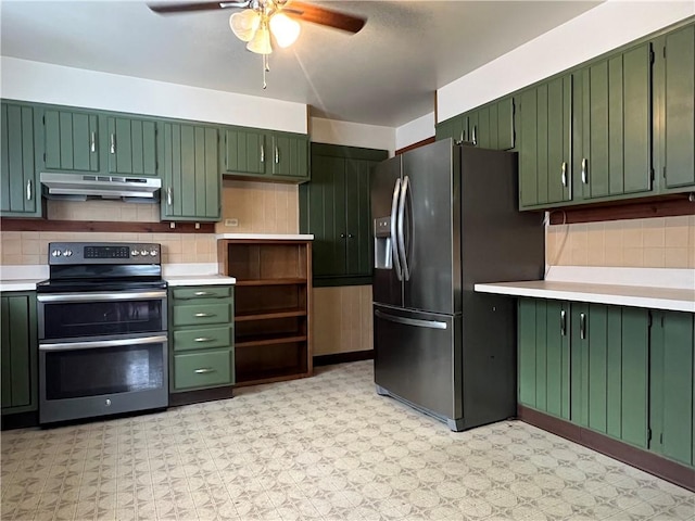 kitchen featuring stainless steel appliances, green cabinetry, light countertops, and under cabinet range hood