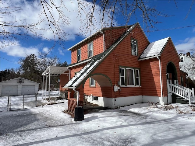 exterior space featuring a garage and an outbuilding