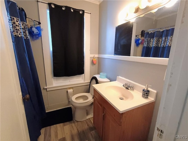 bathroom with toilet, a shower with shower curtain, wood finished floors, and vanity