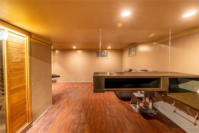 interior space featuring ornamental molding, wood finished floors, and recessed lighting