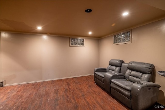 home theater room featuring recessed lighting, crown molding, baseboards, and wood finished floors