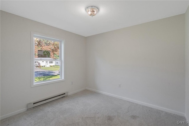 carpeted spare room with baseboard heating and baseboards