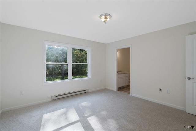 carpeted empty room featuring a baseboard radiator and baseboards