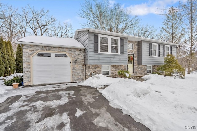 raised ranch with a garage and driveway