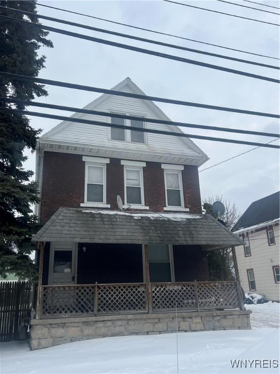 view of front of house with a porch and fence