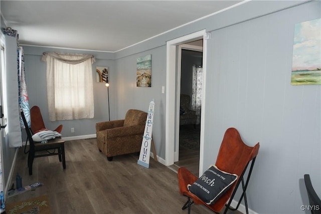 living area with baseboards and wood finished floors