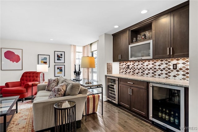 kitchen with beverage cooler and dark brown cabinetry