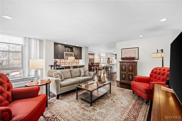 living room featuring a healthy amount of sunlight, light wood-style floors, and recessed lighting