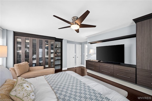 bedroom with dark wood-type flooring, baseboards, and a ceiling fan