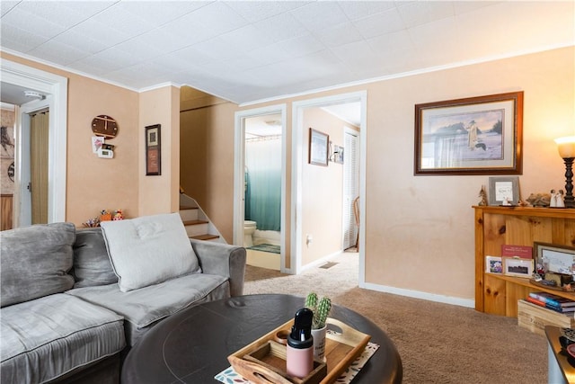 living area with carpet floors, visible vents, baseboards, stairs, and ornamental molding