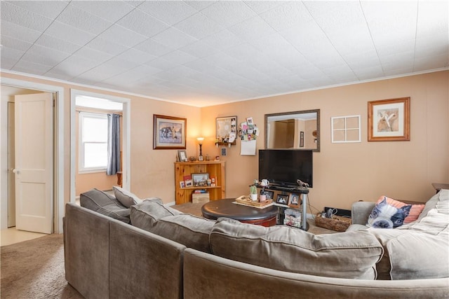 carpeted living room featuring ornamental molding