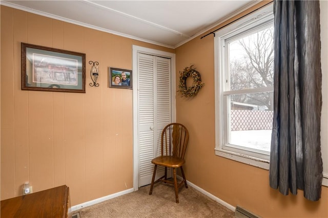 sitting room with a healthy amount of sunlight, baseboards, light carpet, and ornamental molding