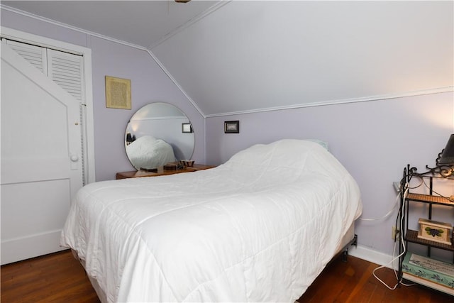 bedroom featuring dark wood-style floors and vaulted ceiling