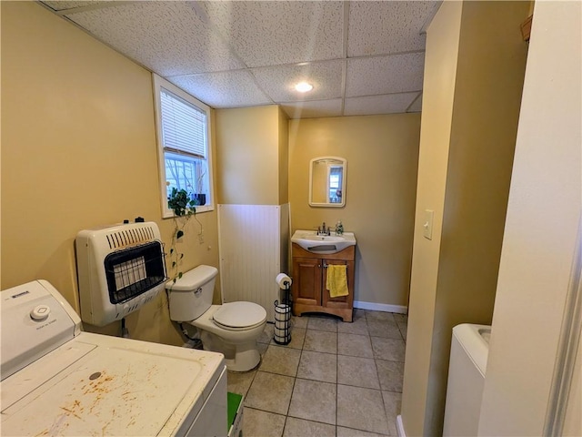 bathroom featuring heating unit, a paneled ceiling, washer / clothes dryer, vanity, and tile patterned floors