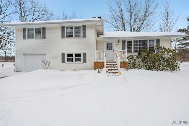 split level home with a garage and a chimney