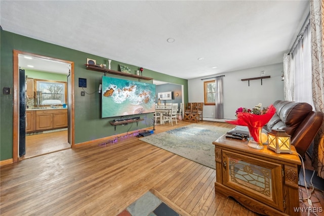 living room featuring baseboards and wood finished floors