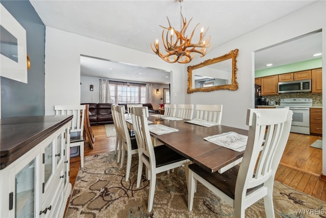 dining room featuring an inviting chandelier and wood finished floors