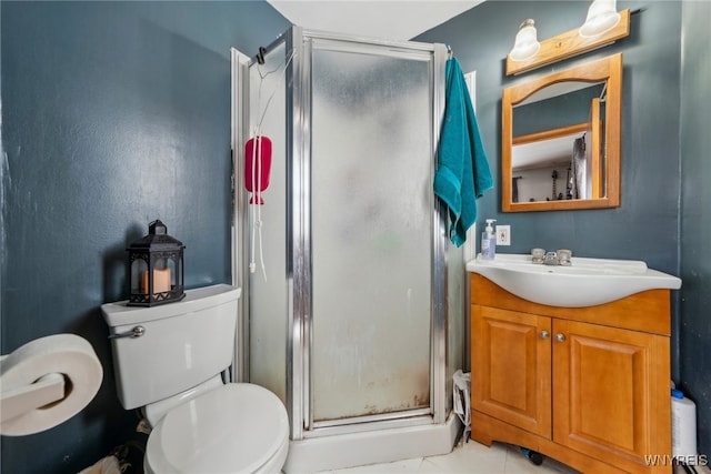 full bathroom featuring a stall shower, vanity, and toilet